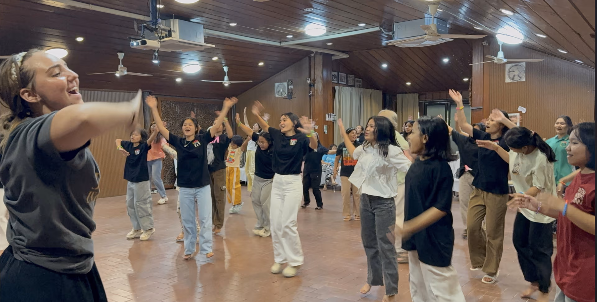 The Faith House girls and team dancing together